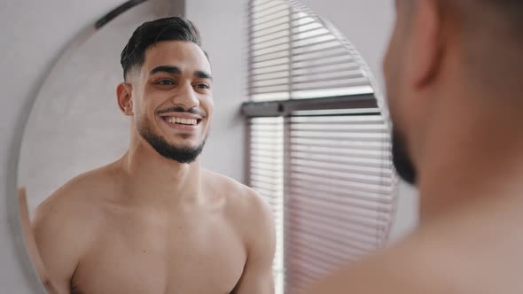 30s Arabian Brunette Indian Model Man with Beard Looking Smiling to Himself Reflection in Mirror in
