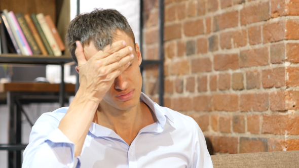 Stressed Businessman with Headache at Work