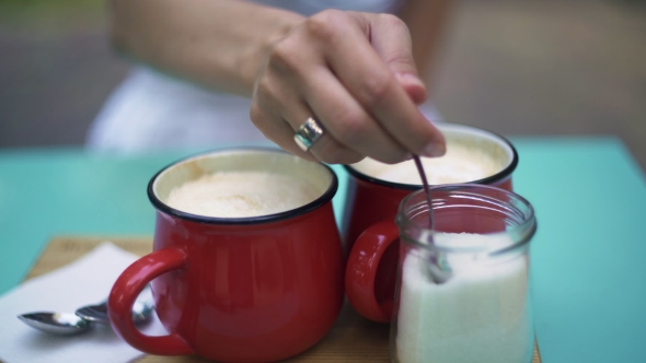 Two Scarlet Cups With Coffee On The Desk.