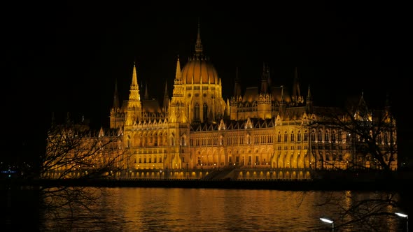 Lighted Parliament building in Budapest and river Danube by the night 4K 2160p UltraHD footage - Riv