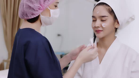 Beauty clinic concept. Young woman getting professional facial procedure.