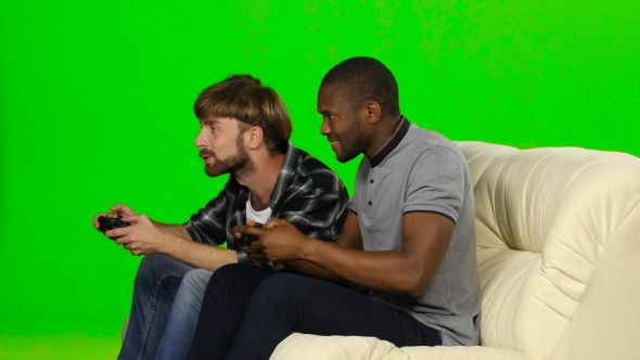 One Of The Guys Wins The Game On The Console. Green Screen
