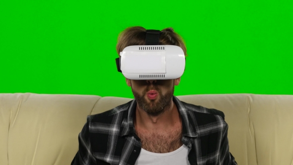 Man Fascinated By The Movie In VR The Mask. Green Screen