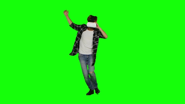 Male Wearing a Mask Of Virtual Reality On His Head. Green Screen