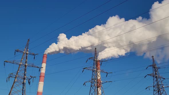 The smoke from the chimney of the industrial plant.