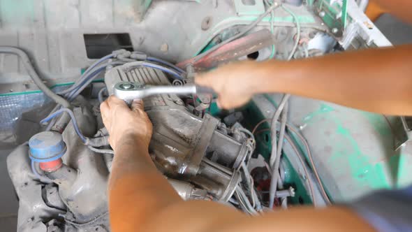 Professional Mechanic Fixing Motor on Old Car Using Tool