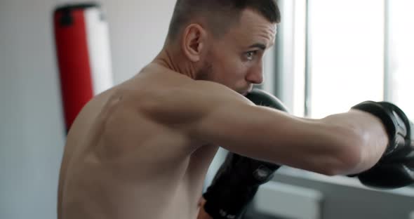 Close Up Shadowboxing in Slow Motion Kickboxer is Fighting with Shadow Fighter is Training Strikes