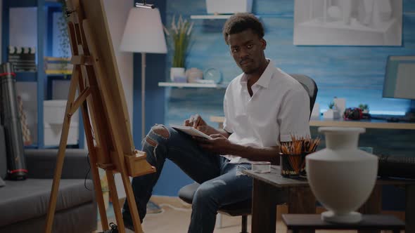 Person of African American Ethnicity Working on Vase Sketch