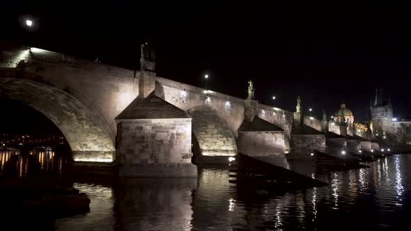 A view of the stone arches of Charles bridge over river Vltava in the historical centre of Prague, C