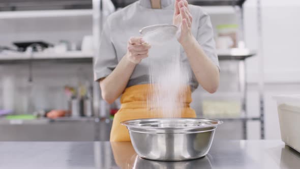 A Bright Girl Cooks Sweet Dishes at a Small Production Facility