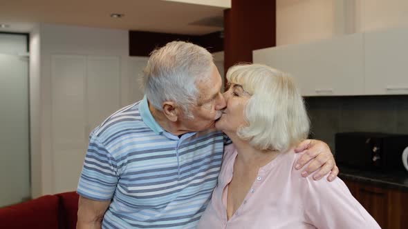 Senior Couple Retired Grandparents Husband and Wife Happy Faces Embracing at Home, Hugging, Laughing