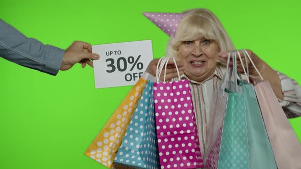 Inscription Up To 30 Percent Off Appears Next To Grandmother. Woman Celebrating with Shopping Bags