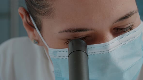 Woman Scientist Using Microscope with Magnifying Glass