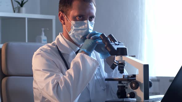 Professional medical doctor working in hospital office using computer technology.