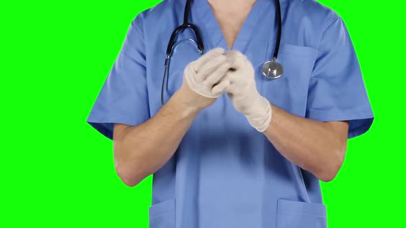 Man Take Off and Puts on His Surgical Gloves. Green Screen. Closeup