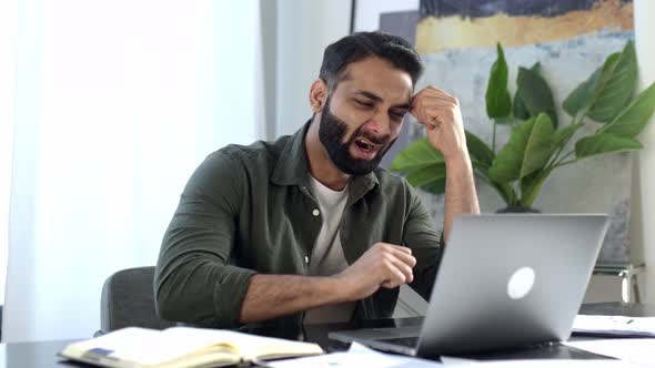 Bored Indian or Arabian Man Freelancer Designer Company Worker Sitting in Modern Office Tired of