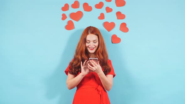 Dreamy Woman with Smartphone Isolated Over Blue Background