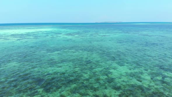 Aerial: uncontaminated coastline tropical beach caribbean sea coral reef atoll