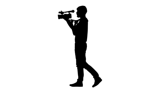 Videographer Conducting Shooting In The Studio. Silhouette. White Background