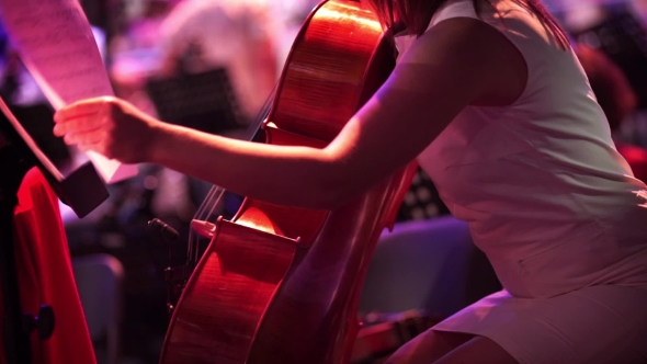 Concert, a Woman In a Short Dress Playing The Cello.
