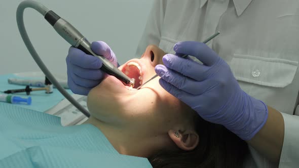 Close up of dentist's hands treating a patient