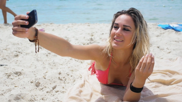 Woman In Pink Bikini Makes Selfie On The Beach