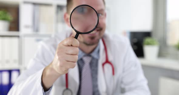 Smiling Male Doctor Looks Through Magnifying Glass  Movie