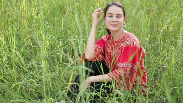 Woman Is Sitting In Tall Grass