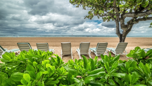 The Sea and the Beach With  Sun Beds In Cloudy Weathe