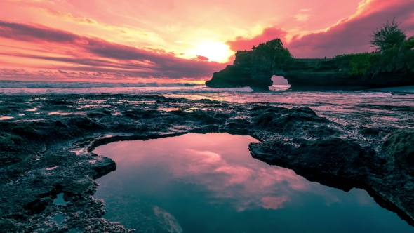 Sunset At Sea Beach Made Of Rocks With Holes Filled By Seawater In Batu Bolong Temple.   - Bali