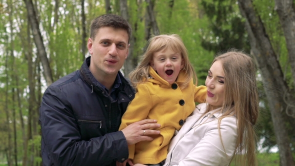 Lovely Parents With Little Doughter In a Park. Slowly