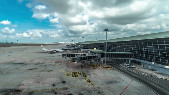 Kuala Lumpur International Airport Ground Crews Servicing The Airplane Prior To Takeoff