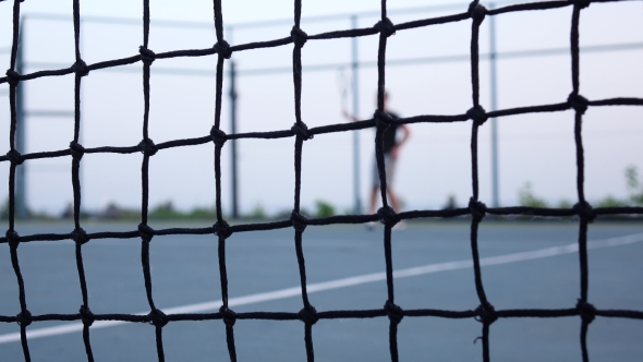 Tennis Player Volleys Using Forehand Technique. Tennis Net In Front
