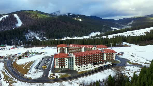 Flying to of the center of Bukovel. In the frame are hotels, a lift, a beautiful forest.