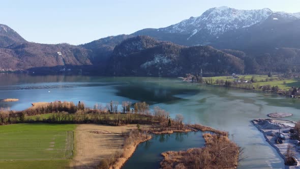 Aerial view of the lake Kochel with the penstocks of a pumped-storage plant in the background