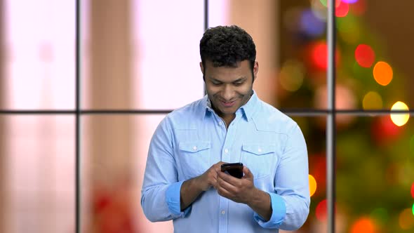 Handsome Man Surfing Internet on His Smartphone