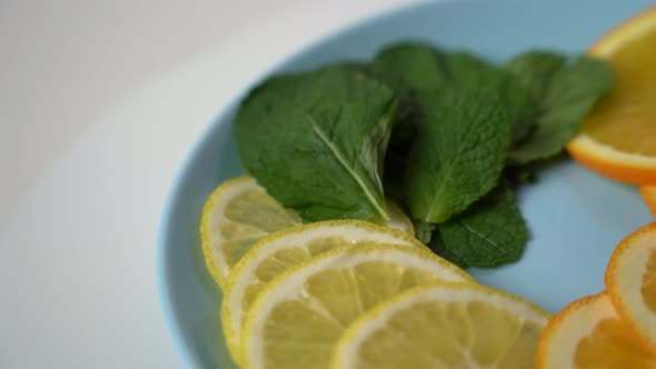 Close-up of of citrus fruit cut in slices on a plate.