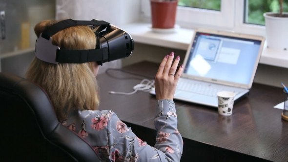 A Woman Working In a Virtual Reality 3D Headset