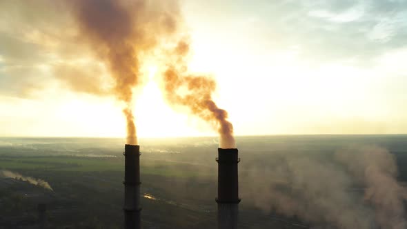 Industrial Zone with a Large Red and White Pipe Thick White Smoke Is Poured From the Factory Pipe in