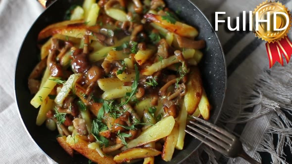 Potatoes With Mushrooms in a Frying Pan