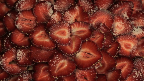 Red Slices Of Fresh Strawberries, Rapidly Rotates Counterclockwise