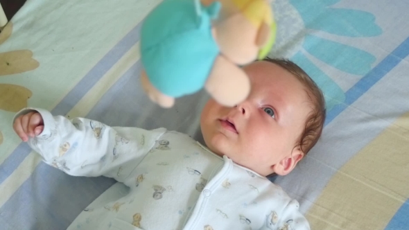 Portrait Of A Baby With Toy Mobile