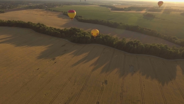 Hot Air Balloons In The Sky Over a field.Aerial View