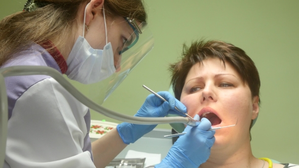 Patient Receiving Dental Care From A Dentist 