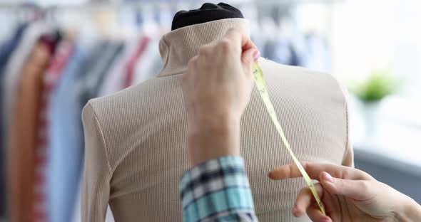 Fashion Designer Takes Measurements with Centimeter From Clothes on Mannequin