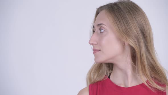 Face of Happy Young Beautiful Blonde Woman Smiling and Looking Away