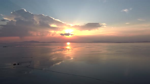 Sunset in Mesologgi Greece. Aerial view of the sunset behind clouds and sea horizon.