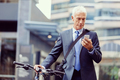Successful businessman on bicycle with mobile phone - PhotoDune Item for Sale