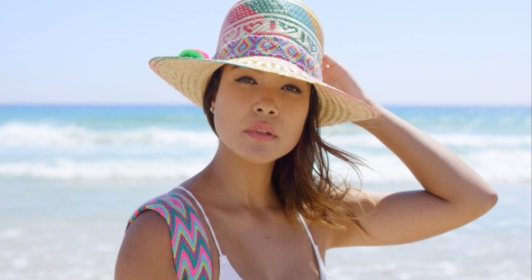 Smiling Young Woman Holding Her Sunhat