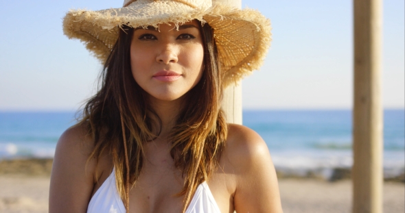 Beauty In White Swim Suit Stares At Camera